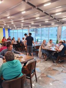 a group of people sitting at tables in a restaurant at Grand Bona Sera Hotel in Istanbul