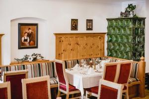 a dining room with a white table and chairs at Hotel Post Abtenau in Abtenau