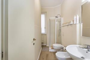 La salle de bains blanche est pourvue de toilettes et d'un lavabo. dans l'établissement Sea View Flat in Rapallo by Wonderful Italy, à Rapallo