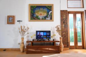 a living room with a tv on a table at Villa Jogja Syariah in Timuran