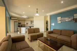 a living room with two couches and a coffee table at Saints View Resort Unit 14 in Uvongo Beach