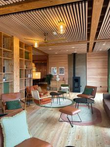 a living room with chairs and tables and a couch at Hôtel le Bout du Parc in Versailles