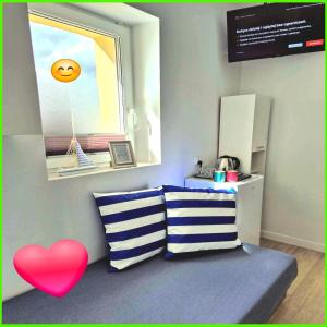 a room with two pillows and a red heart at Rentumi Hostel Gryfino-Noclegi Pracownicze i turystyczne in Gryfino