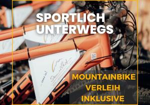 an orange mountain bike with the words spritzer universes at Hotel Samerhof - Badestrand inklusive in Tröpolach