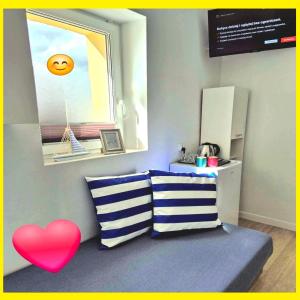 a room with two pillows and a red heart at Rentumi Hostel Gryfino-Noclegi Pracownicze i turystyczne in Gryfino