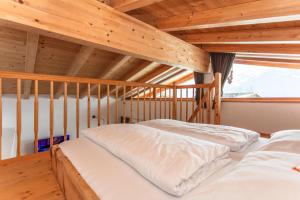 2 łóżka w pokoju z drewnianym sufitem w obiekcie Beim Naglbauer w mieście Piesendorf