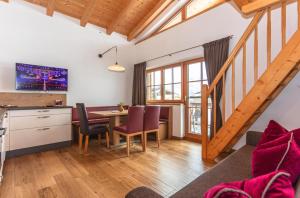 a kitchen and dining room with a table and chairs at Beim Naglbauer in Piesendorf