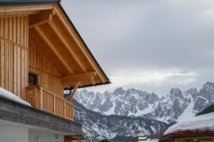 a building with a view of a snow covered mountain at Ferienwohnung Klugis in Gosau