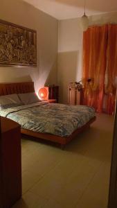 a bedroom with a bed and a lamp in it at Luxury Room Cosenza in Cosenza