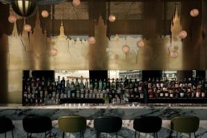 a bar with a lot of bottles of alcohol at The Cloud One Prague in Prague