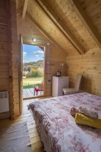 a bedroom with a bed in a wooden house at House Jaksic in Žabljak