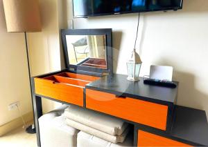 a dresser with a mirror and a laptop on it at Twin Lakes Tagaytay - Cozy Staycation with Sglobal in Laurel