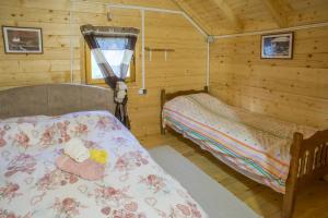 a bedroom with two beds in a log cabin at House Jaksic in Žabljak