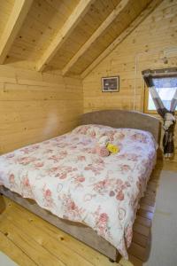 a bedroom with a bed in a wooden room at House Jaksic in Žabljak