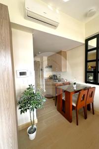 a kitchen and dining room with a table and a plant at Twin Lakes Tagaytay - Cozy Staycation with Sglobal in Laurel