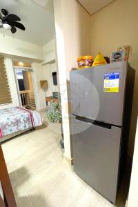 a kitchen with a refrigerator in a room at Twin Lakes Tagaytay - Cozy Staycation with Sglobal in Laurel