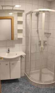 a bathroom with a shower and a sink at Bauernhof Lienharter in Obertilliach