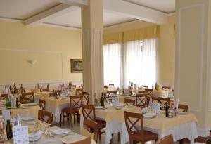 a dining room with tables and chairs and a large window at Hotel Reale in Fiuggi