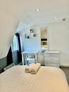 a bedroom with a bed with two towels on it at Comfortable City Centre Room in Bristol