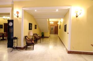 a hallway with a table and chairs in a building at Hotel Reale in Fiuggi