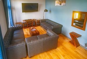 a living room with two couches and a table at Luxury 4 Bedroom Cottage With Stunning Views Near Fairy Pools! Open / Bookable in Carbost