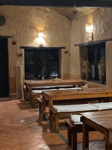 a large room with wooden tables and benches at Prakriti Resort and Organic Farm Pvt. Ltd. in Burhānilkantha