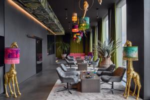 a lobby with chairs and tables and colorful lamps at VISIONAPARTMENTS Glattbrugg in Glattbrugg