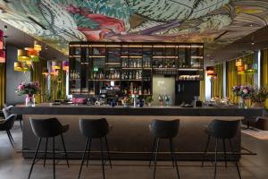 a bar with a mural of flowers on the ceiling at VISIONAPARTMENTS Glattbrugg in Glattbrugg
