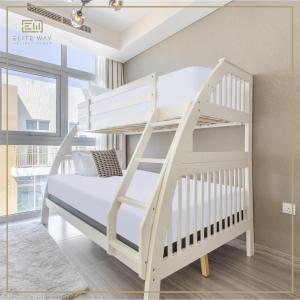 a white bunk bed with a ladder in a room at Impressive 3BR Villa-Akoya in Dubai