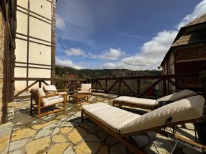 a patio with a couch and chairs on a balcony at Vip Apartments Kopaonik in Kopaonik