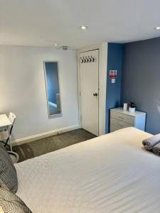 a bedroom with a large white bed and a desk at Large City Centre Room in Bristol