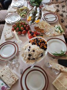 einen Tisch mit Teller mit Lebensmitteln darüber in der Unterkunft Mashtots B&B in Wanadsor