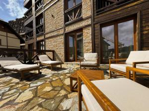a patio with a bunch of chairs and tables at Vip Apartments Kopaonik in Kopaonik