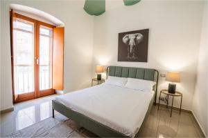 a bedroom with a bed and an elephant picture on the wall at Il Viccio Apartment in Palo del Colle