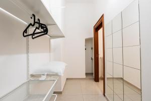 a hallway with white walls and a glass entry way at Il Viccio Apartment in Palo del Colle