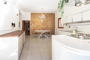 a kitchen with a table and a dining room at Il Viccio Apartment in Palo del Colle