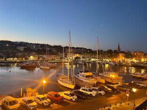 a group of cars parked in a marina at night at Appartement des Ponts Bleus in Martigues
