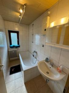 a white bathroom with a tub and a sink at Schöne Wohnung mit Erker 