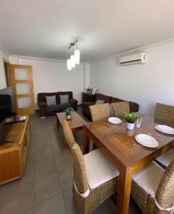 a living room with a wooden table and chairs at UIM Mediterraneo Churruca Wifi in Puerto de Sagunto