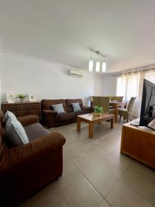 a living room with couches and a tv at UIM Mediterraneo Churruca Wifi in Puerto de Sagunto +12 photos