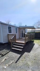 a home with a porch and stairs to a house at CAMPING SIBLU - LA RESERVE **** - Mobile Home - 3 ch. - (8pers) in Gastes