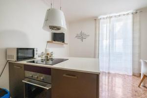 a kitchen with a sink and a microwave at Nel cuore di Torino in Turin