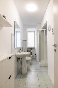 a white bathroom with a sink and a toilet at Nel cuore di Torino in Turin