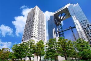 two tall buildings with trees in front of them at The Westin Osaka in Osaka