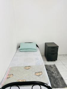 a small bedroom with a bed and a dresser at Boys accommodation in Sharjah