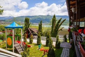 a play area with a playground and a house at AQUA RESORT in Plav