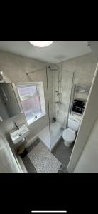 a bathroom with a shower and a toilet and a sink at 3-Bed House, Birmingham in Birmingham