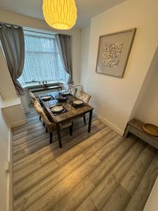 a dining room with a table and a sink at 3-Bed House, Birmingham in Birmingham
