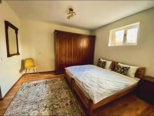 ein Schlafzimmer mit einem Bett und einem gelben Stuhl in der Unterkunft Gudauri Deka House in Gudauri