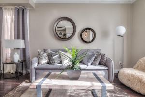 a living room with a couch and a table at Premier Villas in Ajax